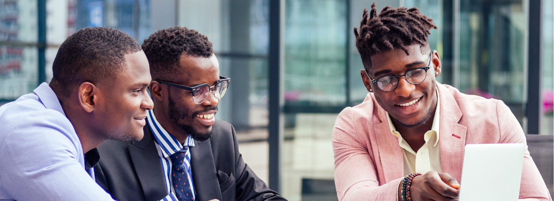 Three black businessmen working on laptop