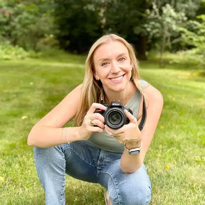 Photo of Sarah Cincotta, Aperian employee, holding her camera and smiling