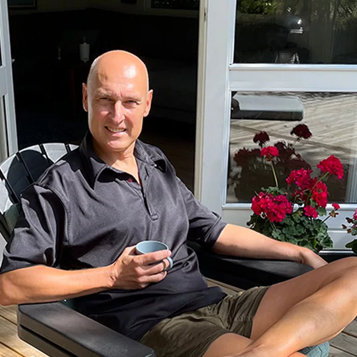 Photo of Aperian employee, Torben Rasmussen, enjoying a cup of coffee seated outside