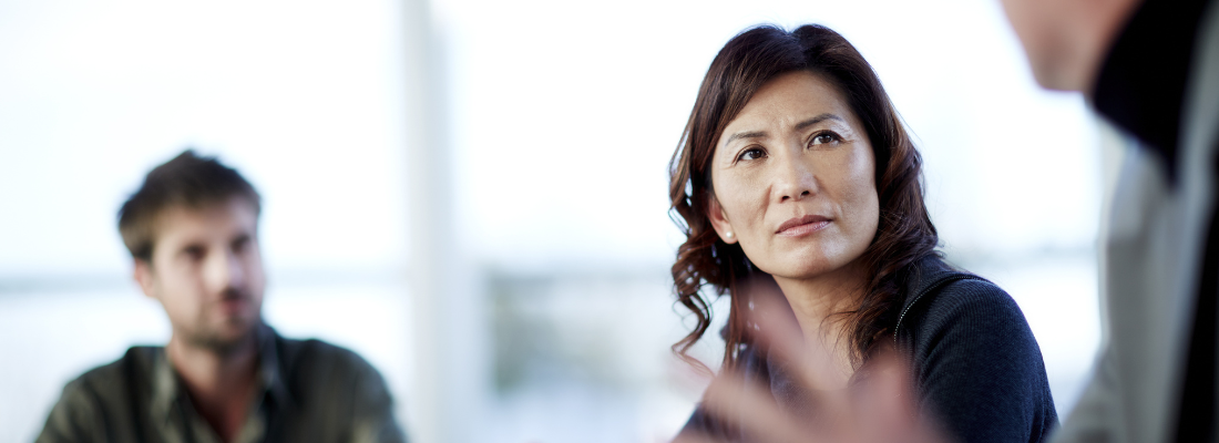 Asian woman in a meeting with colleagues