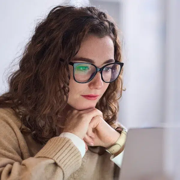 woman looking at computer screen learning about Aperian's platform