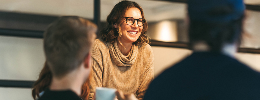 woman smiling in meeting with colleagues