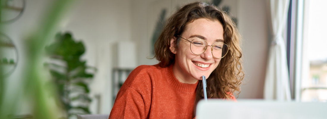 a professional woman working on a laptop at home