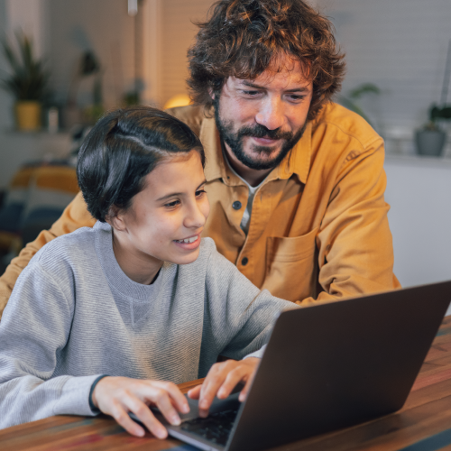 Father and daughter learning on the laptop