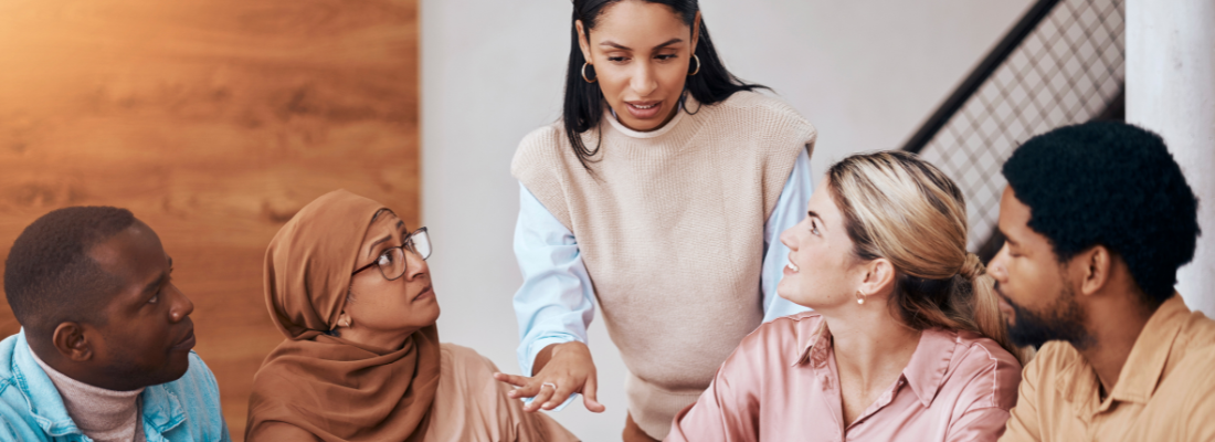 a diverse group of professionals conversing in a workplace environment