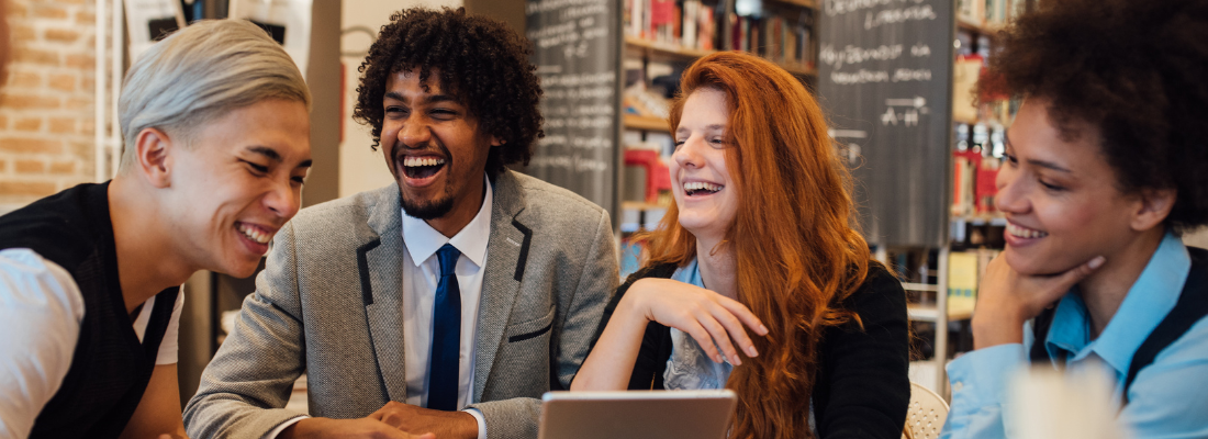 diverse professionals laughing and smiling in a workplace setting