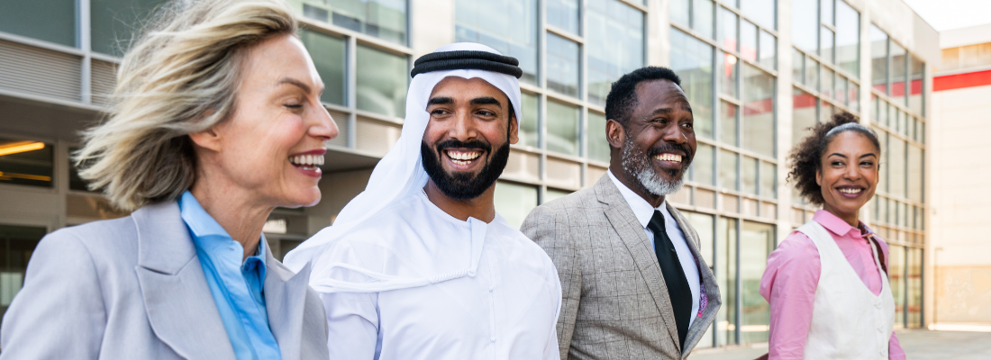 diverse professionals smiling together outside of an office building